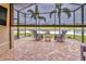 Screened lanai with comfortable seating area and beautiful views of the pond at 4949 Marble Springs Cir, Wimauma, FL 33598
