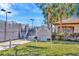 Well-maintained tennis court area with palm trees, a rule sign, and AED with lush landscaping at 4949 Marble Springs Cir, Wimauma, FL 33598