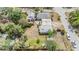 Aerial view of a home with a two-car garage, partial fencing, and adjacent pink house at 5101 13Th S Ave, Gulfport, FL 33707