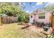 Spacious backyard with patio area, lush lawn, and mature trees at 5101 13Th S Ave, Gulfport, FL 33707
