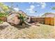 Large backyard with a brick patio, green grass, and mature tropical landscaping at 5101 13Th S Ave, Gulfport, FL 33707