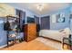 Comfortable bedroom featuring hardwood floors, chest, and ocean-themed decor, perfect for relaxation at 5101 13Th S Ave, Gulfport, FL 33707