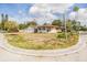 Exterior view of home with a three-car garage, a lawn, and curb appeal enhanced by lush trees and sky at 5101 13Th S Ave, Gulfport, FL 33707
