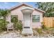 Property exterior with a covered front porch and wooden fence, showcasing curb appeal with trees at 5101 13Th S Ave, Gulfport, FL 33707