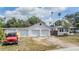 Home exterior with a three-car garage and driveway, offering ample parking space and a touch of curb appeal at 5101 13Th S Ave, Gulfport, FL 33707