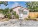 Charming front exterior of a pink home with a covered entry and lush landscaping at 5101 13Th S Ave, Gulfport, FL 33707