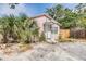 Charming front exterior of a pink home with a covered entry and lush landscaping at 5101 13Th S Ave, Gulfport, FL 33707