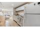 Long kitchen has a white refrigerator, butcher block countertops, and flows into the living room at 5101 13Th S Ave, Gulfport, FL 33707