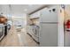 Long white kitchen features a gas stove, and butcher block countertops, with refrigerator at 5101 13Th S Ave, Gulfport, FL 33707