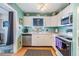 Well-maintained kitchen featuring white cabinets, stainless steel appliances, and plenty of counter space at 5101 13Th S Ave, Gulfport, FL 33707