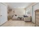 Bright living room features a large sectional sofa, tile floors, and natural light at 5101 13Th S Ave, Gulfport, FL 33707