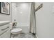 Bathroom featuring tiled shower-tub with a patterned curtain and a mounted towel rack at 5437 Del Coronado Dr, Apollo Beach, FL 33572