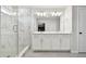 Beautiful bathroom showcasing dual sinks, modern lighting, quartz countertop, and a large glass shower at 5437 Del Coronado Dr, Apollo Beach, FL 33572