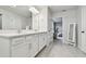 Bright bathroom includes dual sink vanity, tile floors, and open doorway to bedroom providing a seamless flow at 5437 Del Coronado Dr, Apollo Beach, FL 33572