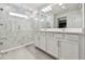 Spa-like bathroom features a large glass enclosed shower with marble tile and dual sink vanity at 5437 Del Coronado Dr, Apollo Beach, FL 33572
