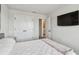 Bedroom featuring a cozy bed, closet doors, and an attached bathroom entrance at 5437 Del Coronado Dr, Apollo Beach, FL 33572