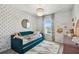 Charming bedroom design with floral accent wall, stylish chandelier, and a comfortable pull-out daybed at 5437 Del Coronado Dr, Apollo Beach, FL 33572