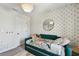 Stylized bedroom with modern daybed, patterned wallpaper and whimsical decor at 5437 Del Coronado Dr, Apollo Beach, FL 33572