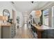 Hallway with dining area, modern light fixture, hardwood floors, and view to the front door at 5437 Del Coronado Dr, Apollo Beach, FL 33572