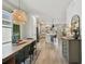 Dining room with modern chandelier, hardwood floors, and view to the kitchen at 5437 Del Coronado Dr, Apollo Beach, FL 33572