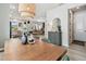 Dining room with wood table, modern lighting, and open view to the kitchen and living spaces at 5437 Del Coronado Dr, Apollo Beach, FL 33572