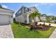 Two-story home with gray siding, white trim, and a well-manicured lawn, reflecting modern elegance and charm at 5437 Del Coronado Dr, Apollo Beach, FL 33572