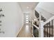Bright foyer features a modern front door, staircase, and wood-look flooring at 5437 Del Coronado Dr, Apollo Beach, FL 33572