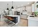 Spacious kitchen with white cabinets, stainless steel appliances, large island with seating, and open layout at 5437 Del Coronado Dr, Apollo Beach, FL 33572
