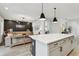 Open-concept layout with a large island connecting the modern kitchen to the stylishly decorated living area at 5437 Del Coronado Dr, Apollo Beach, FL 33572