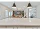 Bright kitchen with a large quartz island that opens into a well-lit living room and office space at 5437 Del Coronado Dr, Apollo Beach, FL 33572