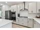 Modern kitchen with stainless steel appliances, white cabinets, and a view of the island at 5437 Del Coronado Dr, Apollo Beach, FL 33572
