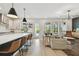 Bright kitchen with island seating, flowing seamlessly into the living area and outdoor pool view at 5437 Del Coronado Dr, Apollo Beach, FL 33572