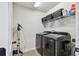 Well-organized laundry room features modern washer and dryer, storage shelves, and ample space at 5437 Del Coronado Dr, Apollo Beach, FL 33572