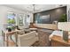 Well-lit living room with modern furniture and a view of the outdoor pool at 5437 Del Coronado Dr, Apollo Beach, FL 33572