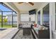 Outdoor seating on covered patio with fan and TV at 5437 Del Coronado Dr, Apollo Beach, FL 33572