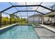 Enjoy the beautiful screened-in pool with an attached spa and plenty of space for outdoor lounging at 5437 Del Coronado Dr, Apollo Beach, FL 33572