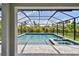 The pool area has clear, blue water surrounded by a patio and an enclosed lanai offering a great view at 5437 Del Coronado Dr, Apollo Beach, FL 33572