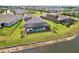 Aerial view of backyard featuring a screened-in pool and lush green lawn at 5477 Wayfarer Ave, Apollo Beach, FL 33572