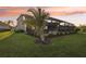 The spacious backyard features a screened-in pool, landscaping, and a tropical palm tree at 5477 Wayfarer Ave, Apollo Beach, FL 33572