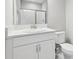Bathroom with white cabinets, white countertop, and glass-enclosed shower at 5477 Wayfarer Ave, Apollo Beach, FL 33572