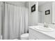 Neutral bathroom with a standard toilet, white vanity, and shower with a clean white curtain at 5477 Wayfarer Ave, Apollo Beach, FL 33572