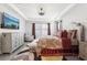 This primary bedroom features a decorative ceiling, natural light, and an elegantly tufted headboard at 5477 Wayfarer Ave, Apollo Beach, FL 33572