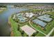 Aerial view of community amenities including tennis and basketball courts, swimming pools, and lake access at 5477 Wayfarer Ave, Apollo Beach, FL 33572
