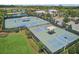 Aerial image of community tennis courts and pickleball courts, shaded picnic tables for residents at 5477 Wayfarer Ave, Apollo Beach, FL 33572