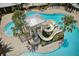 Overhead image showcasing a community pool with a spiral water slide and surrounding palm trees at 5477 Wayfarer Ave, Apollo Beach, FL 33572