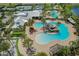 Aerial view of a resort-style community pool with a splash pad, waterslide, and ample seating areas at 5477 Wayfarer Ave, Apollo Beach, FL 33572