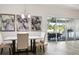 Dining area near the kitchen featuring chairs, marble table, modern art, and sliding glass door to patio at 5477 Wayfarer Ave, Apollo Beach, FL 33572