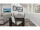 An open dining area features contemporary decor, modern chandelier and gray wood-look flooring at 5477 Wayfarer Ave, Apollo Beach, FL 33572