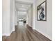 Spacious hallway with hardwood flooring, neutral paint, and a view into the open-concept living area at 5477 Wayfarer Ave, Apollo Beach, FL 33572