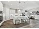 Bright, open kitchen with white cabinets, island seating, stainless steel appliances, and an adjacent dining area at 5477 Wayfarer Ave, Apollo Beach, FL 33572